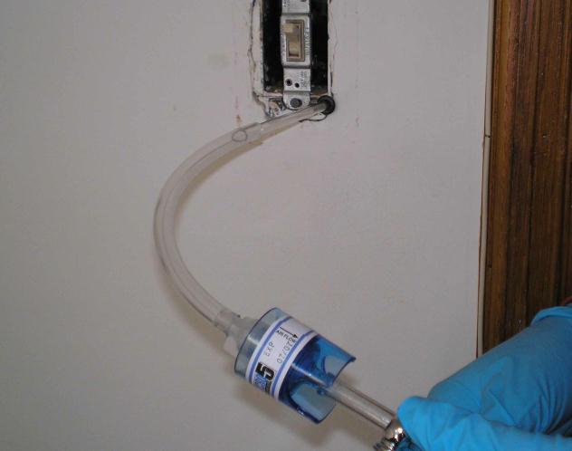 Taking air sample in wall cavity